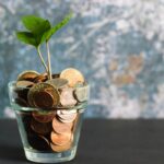 Person working from home on side hustles with laptop and money concepts
