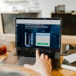 Person celebrating first online payment on laptop